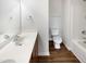 Bathroom with white tub, toilet and sink plus a mirrored vanity at 106 Canvasback Dr, Durham, NC 27704