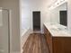 Modern bathroom with a soaking tub, double sink vanity, and wood-look flooring at 106 Canvasback Dr, Durham, NC 27704