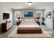 Beautiful staged bedroom with a large bed, nightstands, lamps, and decorative wall art at 106 Canvasback Dr, Durham, NC 27704
