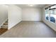 Spacious empty room with neutral carpet, a staircase, and plenty of natural light from a window at 106 Canvasback Dr, Durham, NC 27704