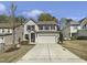 Charming two-story home with a two-car garage, well-manicured lawn, and classic architectural details at 106 Canvasback Dr, Durham, NC 27704