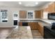 A kitchen with stainless steel sink, laminate countertops and matching wooden cabinets at 106 Canvasback Dr, Durham, NC 27704