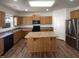 Modern kitchen with stainless steel appliances, an island, wood floors, and ample counter space at 106 Canvasback Dr, Durham, NC 27704