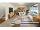 Bright living room featuring stylish furniture, striped rug, decorative shelving, and natural light at 106 Canvasback Dr, Durham, NC 27704