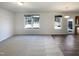 Open-concept living area featuring carpeted floors, large windows, and seamless flow into the kitchen at 106 Canvasback Dr, Durham, NC 27704