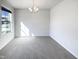 Bright room featuring a large window and neutral carpet, bathed in natural light at 106 Canvasback Dr, Durham, NC 27704