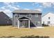 Rear view of house with screened porch and expansive yard, perfect for outdoor living at 110 White Burley Ct, Durham, NC 27703