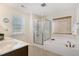 Bright bathroom featuring a separate tub and shower with tiled surround and neutral finishes at 110 White Burley Ct, Durham, NC 27703