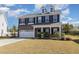 Charming two-story home featuring a brick facade, dormer windows, and a well-maintained lawn at 110 White Burley Ct, Durham, NC 27703