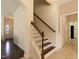 Inviting staircase featuring wood and white trim, leading to the upper level of the home at 110 White Burley Ct, Durham, NC 27703