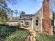Large backyard with patio and brick chimney, perfect for outdoor entertaining at 112 Old Bridge Ln, Chapel Hill, NC 27517