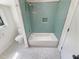 Bright white tiled bathroom with a bath and shower combo at 112 Old Bridge Ln, Chapel Hill, NC 27517