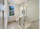 Bright bathroom featuring a glass shower, toilet, and natural light from a window at 112 Old Bridge Ln, Chapel Hill, NC 27517