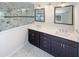 Elegant bathroom featuring dual sinks, marble countertops, and a glass-enclosed shower at 112 Old Bridge Ln, Chapel Hill, NC 27517