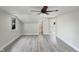 Bright attic bedroom featuring stylish flooring, a ceiling fan, and large windows at 112 Old Bridge Ln, Chapel Hill, NC 27517