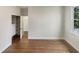 Clean bedroom with hardwood floors, a closet with built-in shelves, and a bright window at 112 Old Bridge Ln, Chapel Hill, NC 27517
