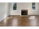 Bright living room featuring hardwood floors and a brick fireplace, ready for personalization at 112 Old Bridge Ln, Chapel Hill, NC 27517