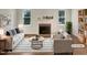 Bright living room with a brick fireplace, sleek furniture, and neutral color palette at 112 Old Bridge Ln, Chapel Hill, NC 27517