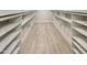 Spacious walk-in closet featuring built-in shelving and wood-look flooring at 112 Old Bridge Ln, Chapel Hill, NC 27517