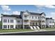 Beautiful exterior elevation of a multi-story home with a well-manicured lawn at 11549 Helmond Way # 116, Raleigh, NC 27617