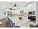 Bright kitchen boasts white cabinets, stainless steel appliances, and a large island with seating at 11549 Helmond Way # 116, Raleigh, NC 27617