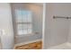 Bright bathroom features wood-look floors, a window with blinds, and neutral wall color at 1171 Jackson Ct, Creedmoor, NC 27522