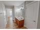 A stunning bathroom featuring dual sinks, a rich wood vanity and well-lit mirror at 1171 Jackson Ct, Creedmoor, NC 27522
