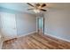 Spacious bedroom features wood-look flooring, ceiling fan, and neutral paint for a modern, airy feel at 1171 Jackson Ct, Creedmoor, NC 27522