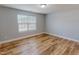 This cozy bedroom has natural light, modern vinyl flooring and a neutral color palette at 1171 Jackson Ct, Creedmoor, NC 27522