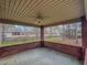 Relaxing covered patio with fan, views of the tree-lined backyard and a neighboring home at 1171 Jackson Ct, Creedmoor, NC 27522