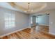 Open-concept dining room with modern lighting fixture, wood-look floors, and natural light at 1171 Jackson Ct, Creedmoor, NC 27522
