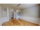Dining area with wood floors, decorative wall trim, and modern lighting fixtures, perfect for entertaining at 1171 Jackson Ct, Creedmoor, NC 27522