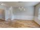 Dining area with wood flooring, panel molding, and modern lighting fixtures, ideal for Gathering dinners at 1171 Jackson Ct, Creedmoor, NC 27522