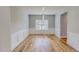 Bright dining room with wood floors, panel molding, and a modern chandelier, creating an inviting space at 1171 Jackson Ct, Creedmoor, NC 27522