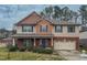 Two-story home with brick and siding, featuring a two-car garage and landscaped front yard at 1171 Jackson Ct, Creedmoor, NC 27522