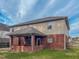 Back view of the house, showing the siding, brick, and a covered patio at 1171 Jackson Ct, Creedmoor, NC 27522