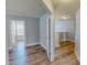 Hallway showcases wood-look floors and connects various rooms with white-trimmed doorways at 1171 Jackson Ct, Creedmoor, NC 27522