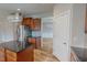 Kitchen featuring an island, stainless steel fridge, and wood cabinets, with an open view to the dining area at 1171 Jackson Ct, Creedmoor, NC 27522