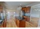 Modern kitchen featuring stainless steel appliances, black countertops, and warm wood cabinets at 1171 Jackson Ct, Creedmoor, NC 27522