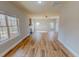 Spacious living room with wood floors, a fireplace, and large windows offering ample natural light at 1171 Jackson Ct, Creedmoor, NC 27522