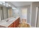 Main bathroom featuring dual sinks, ample counter space, and wood-look floors at 1171 Jackson Ct, Creedmoor, NC 27522