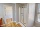 Modern bathroom with glass-enclosed shower and wood-look floors at 1171 Jackson Ct, Creedmoor, NC 27522