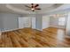 Bright main bedroom featuring a tray ceiling, ceiling fan, and wood-look floors at 1171 Jackson Ct, Creedmoor, NC 27522