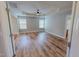 Spacious main bedroom featuring wood-look floors, a tray ceiling, and a ceiling fan at 1171 Jackson Ct, Creedmoor, NC 27522