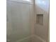A bathtub in a modern bathroom features unique patterned tiles and a built-in storage niche at 1216 Barcroft Pl, Raleigh, NC 27615
