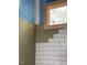 Bathroom under construction with new white subway tile and a window at 1216 Barcroft Pl, Raleigh, NC 27615