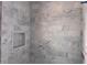 Shower featuring marble tiling, a recessed shelf, and modern fixtures at 1216 Barcroft Pl, Raleigh, NC 27615