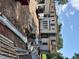 Side view of two-story house showing white exterior, multiple windows, and construction materials at 1216 Barcroft Pl, Raleigh, NC 27615