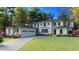 Beautiful two-story home with a three car garage, lush landscaping, and a well-manicured lawn at 1216 Barcroft Pl, Raleigh, NC 27615