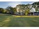 Stunning home exterior on the golf course with lush green lawns and mature trees at 1216 Barcroft Pl, Raleigh, NC 27615